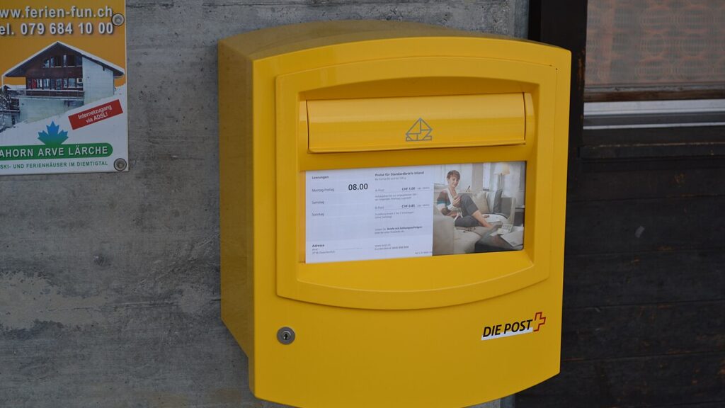 Ein gelber Briefkasten der Schweizerischen Post als Symbolbild